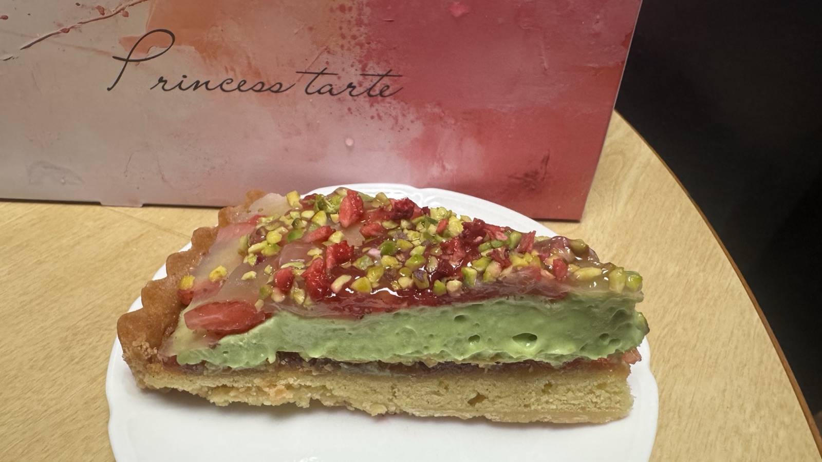 A slice of strawberry and pistachio napoleon pie tart on a plate at Princess Tart Kichijoji