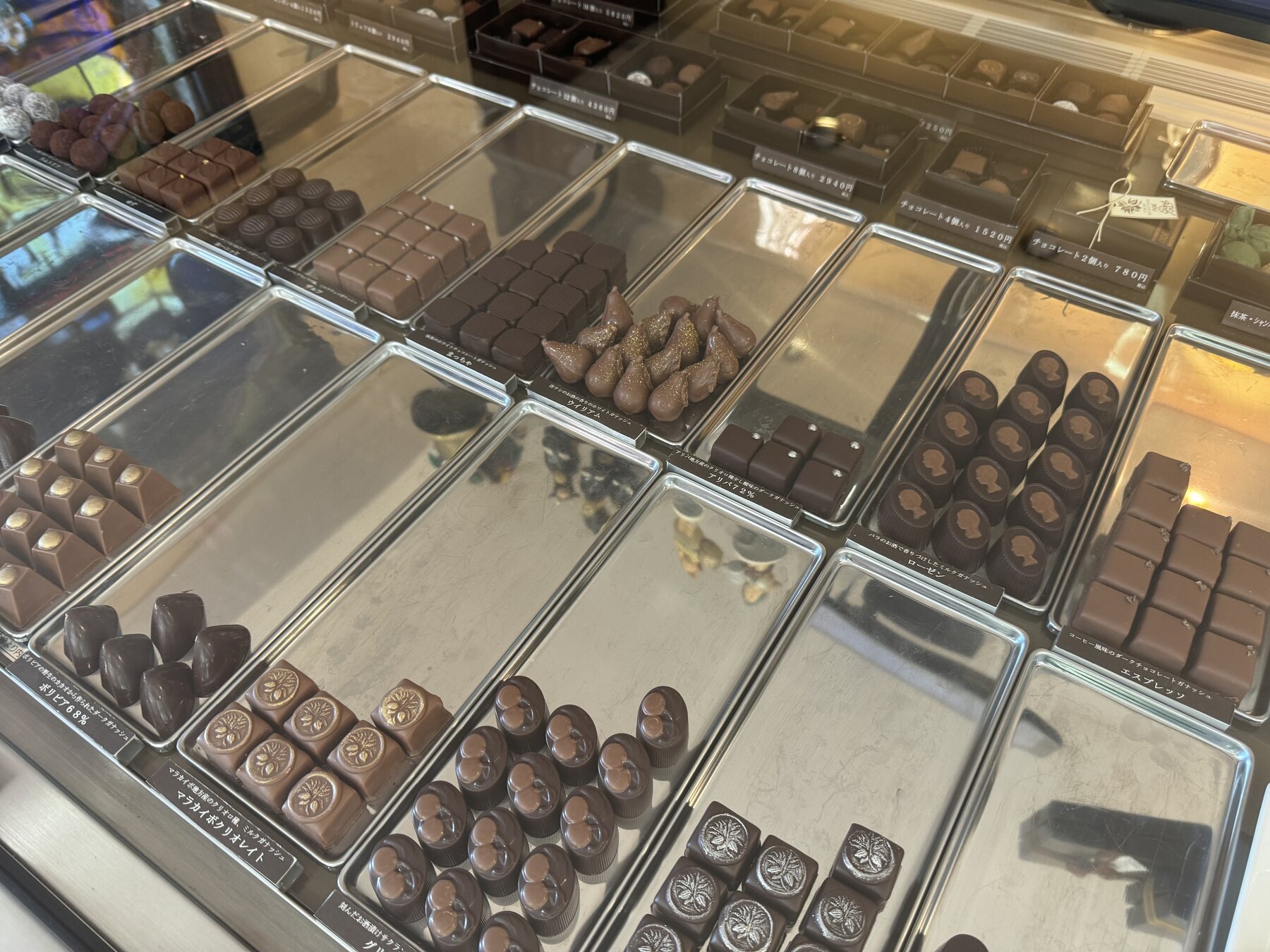 Trays of handmade chocolates and bonbons in the display case at Okashinoie Noe, a long-established Western confectionery shop in Shimo-Shakujii, Nerima, Tokyo.