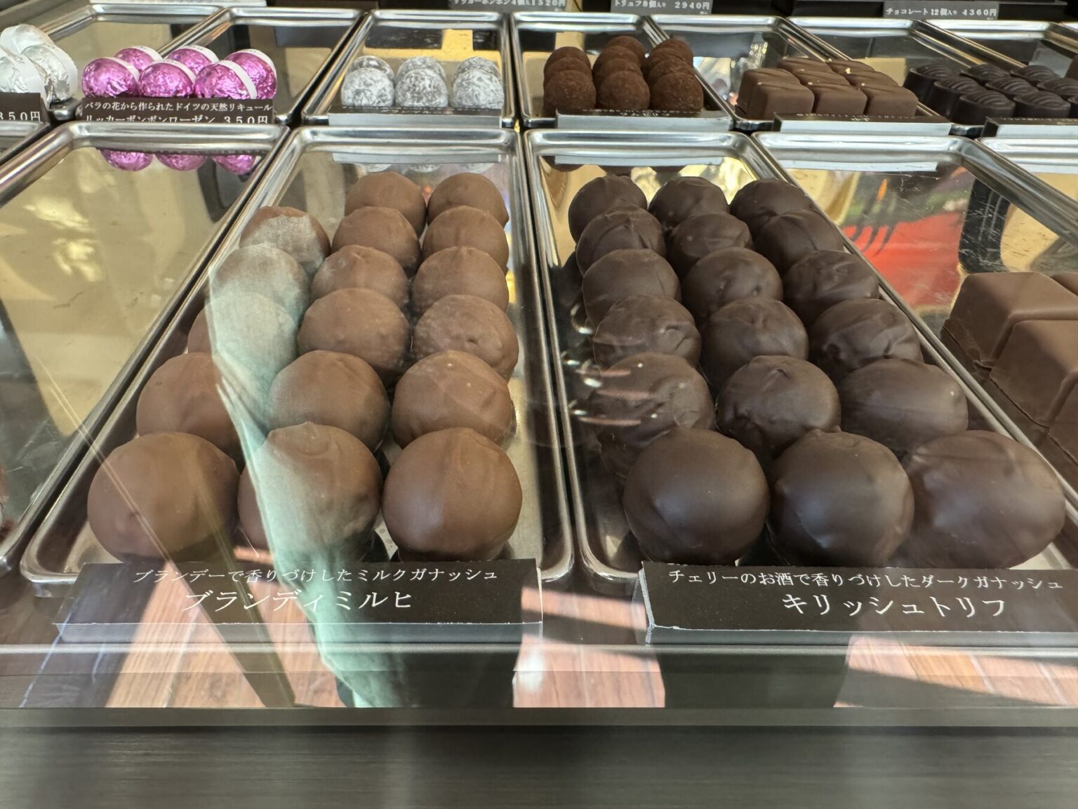 Rows of chocolate-glazed cream puffs and Kirschtorte truffles behind glass at Okashinoie Noe, the Nerima cake shop that has baked in Tokyo's Shakujii neighbourhood since 1975.