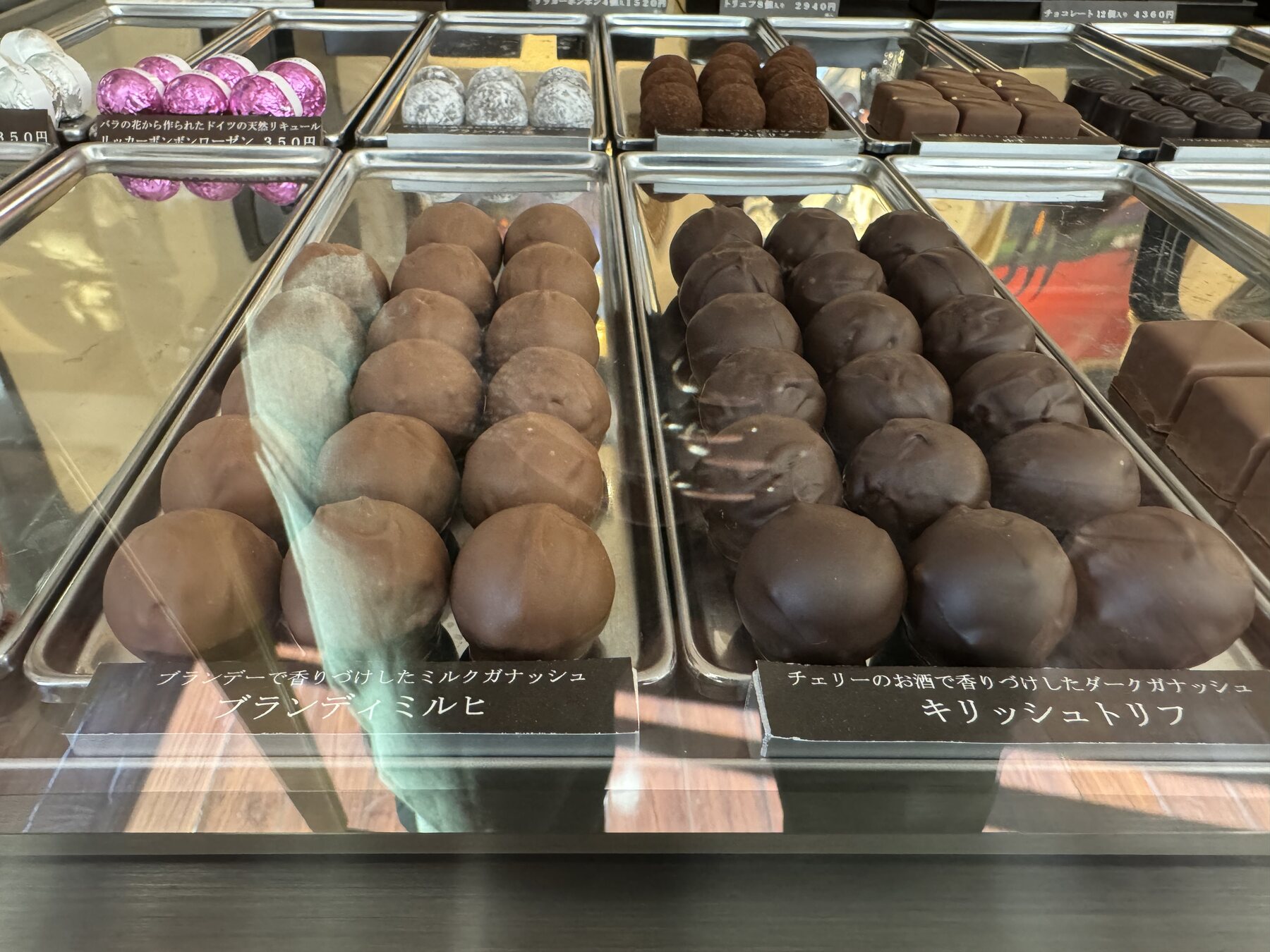 Rows of chocolate-glazed cream puffs and Kirschtorte truffles behind glass at Okashinoie Noe, the Nerima cake shop that has baked in Tokyo's Shakujii neighbourhood since 1975.