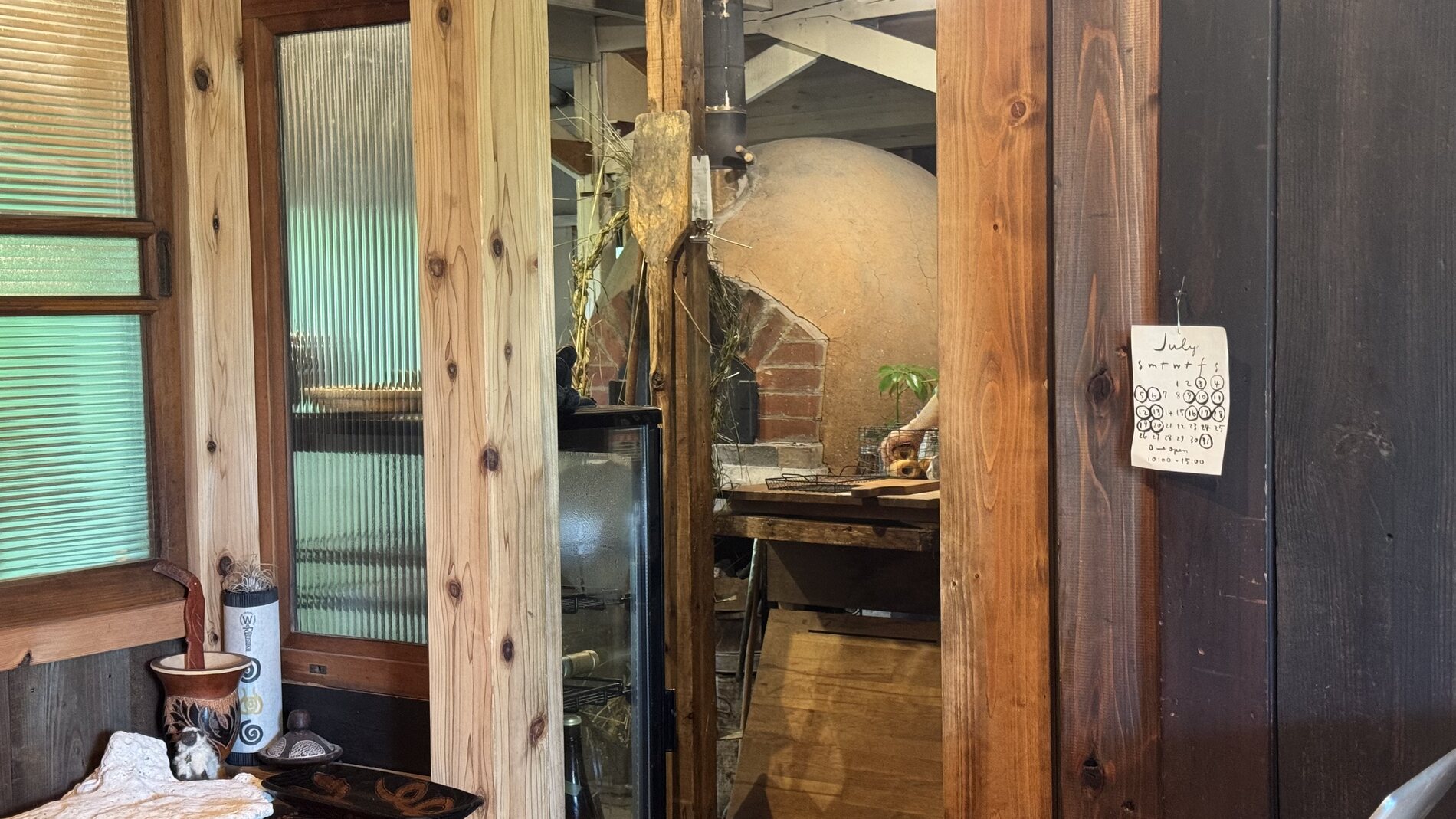 A doorway inside Pandian's wooden house on Lake Kawaguchi, looking through toward the timber-framed baking area of the natural-yeast bakery in Fujikawaguchiko.