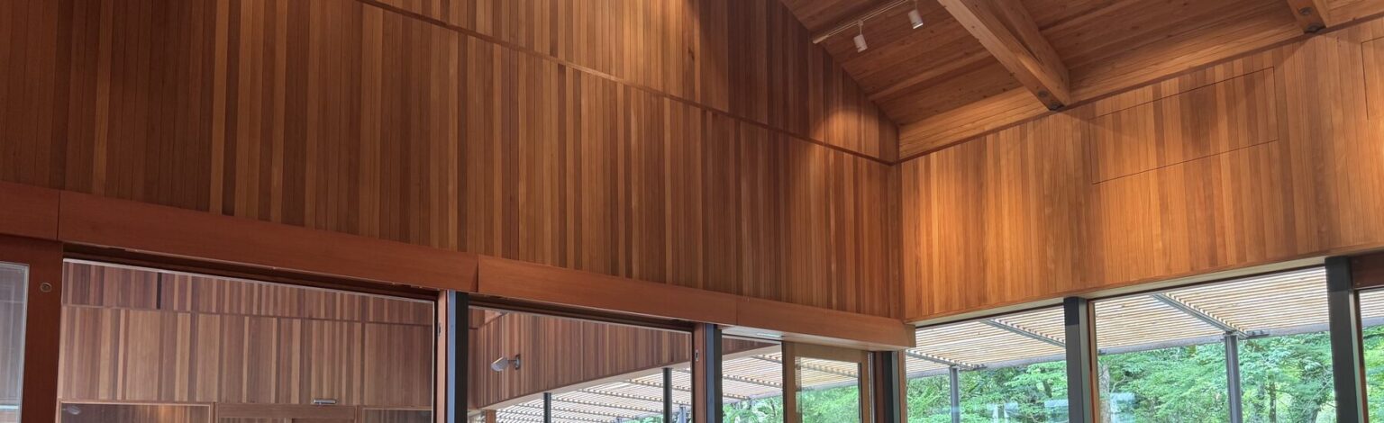 The soaring cedar ceiling and high wooden walls of the Naito Hiroshi-designed Toraya Kobo cafe above garden-view windows in Gotemba, Shizuoka