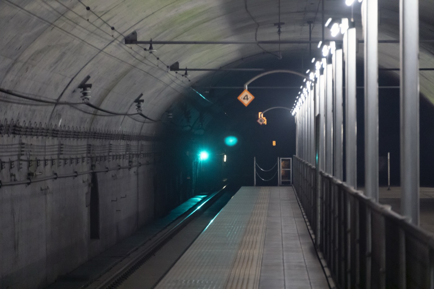 The dimly lit underground platform of Doai Station, set inside the Shin-Shimizu rail tunnel about 70 metres below the surface, Minakami, Gunma