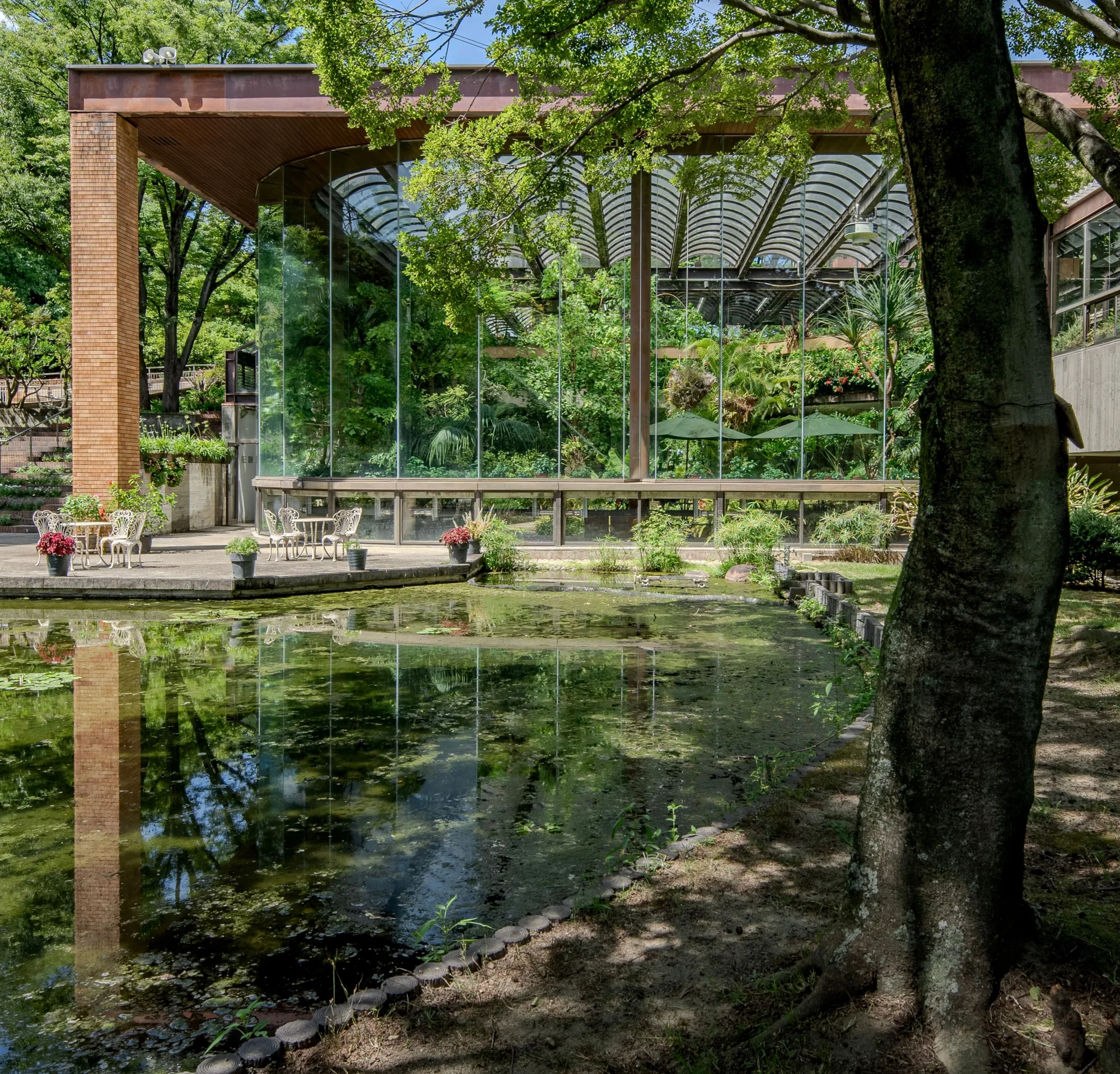 The modernist glass greenhouse of the Flower and Green Consultation Center at Hattori Ryokuchi, Osaka