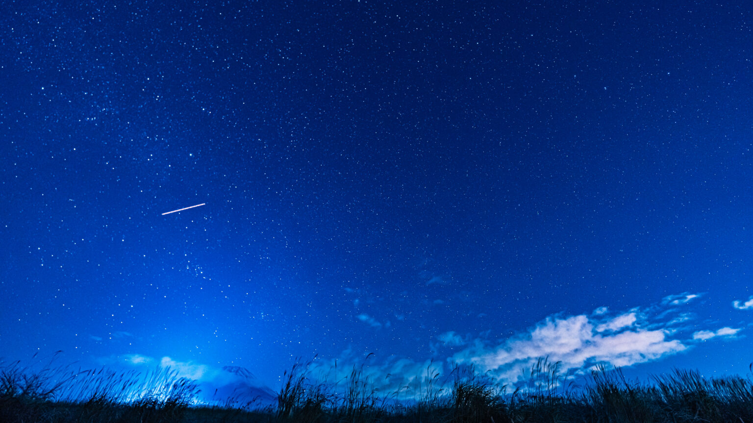 Starry night sky with a streak over Mt. Fuji from Jurigi Kogen