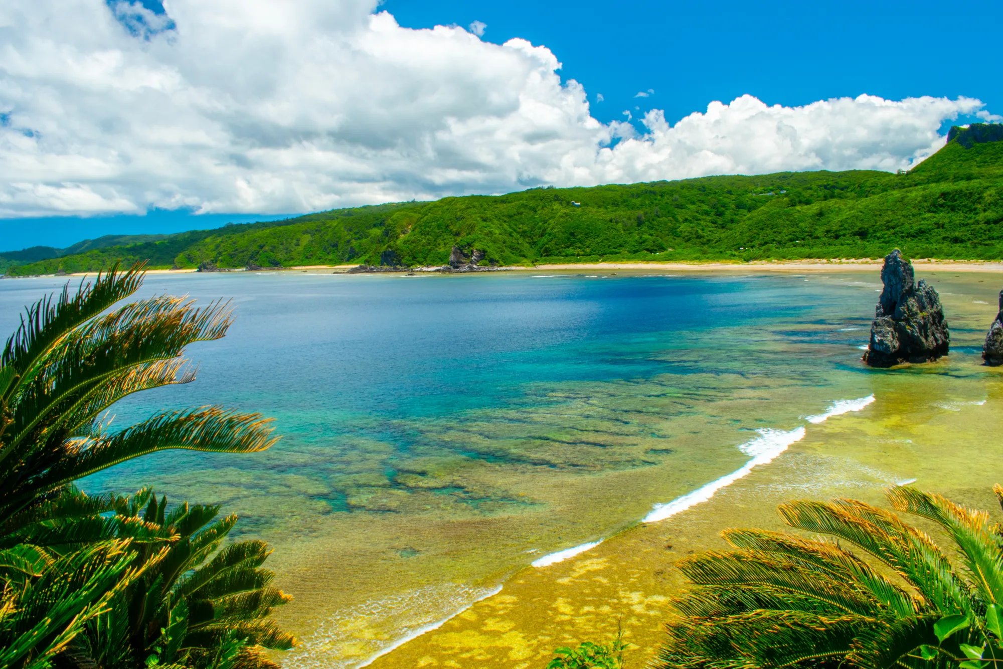 Turquoise reef water and green hills of the northern Okinawa coast near Cape Hedo, Kunigami