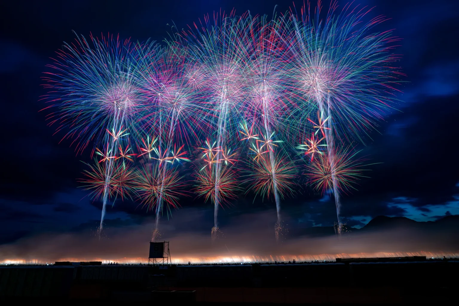 Wide bursts of the Omagari National Fireworks Competition over the Omono River in Daisen Akita