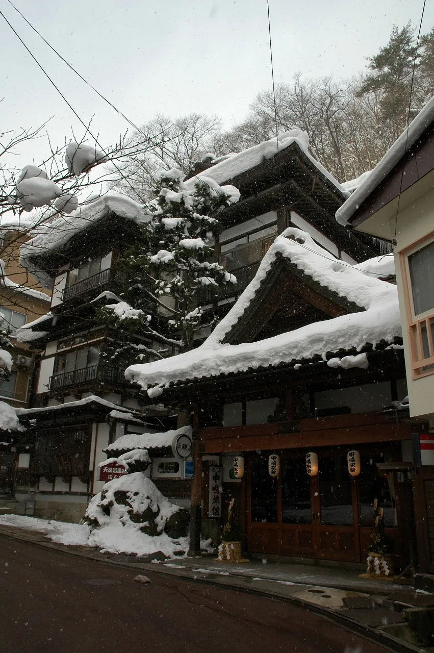 Nakashima Ryokan, a wooden multi-storey inn in Dai Onsen, Hanamaki, in snow