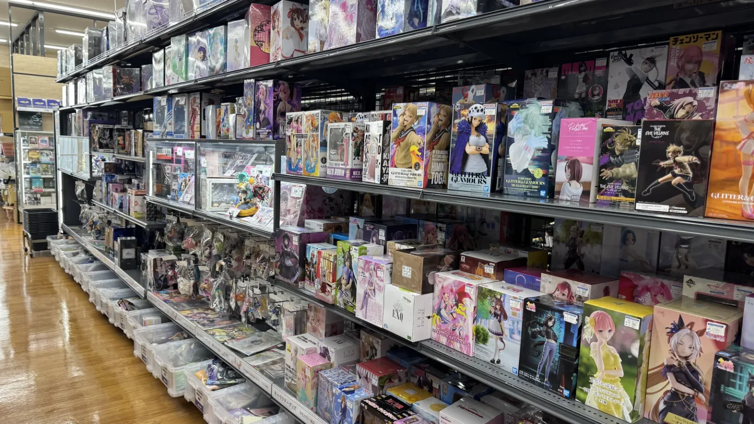 Shelves packed with boxed anime figures and toys