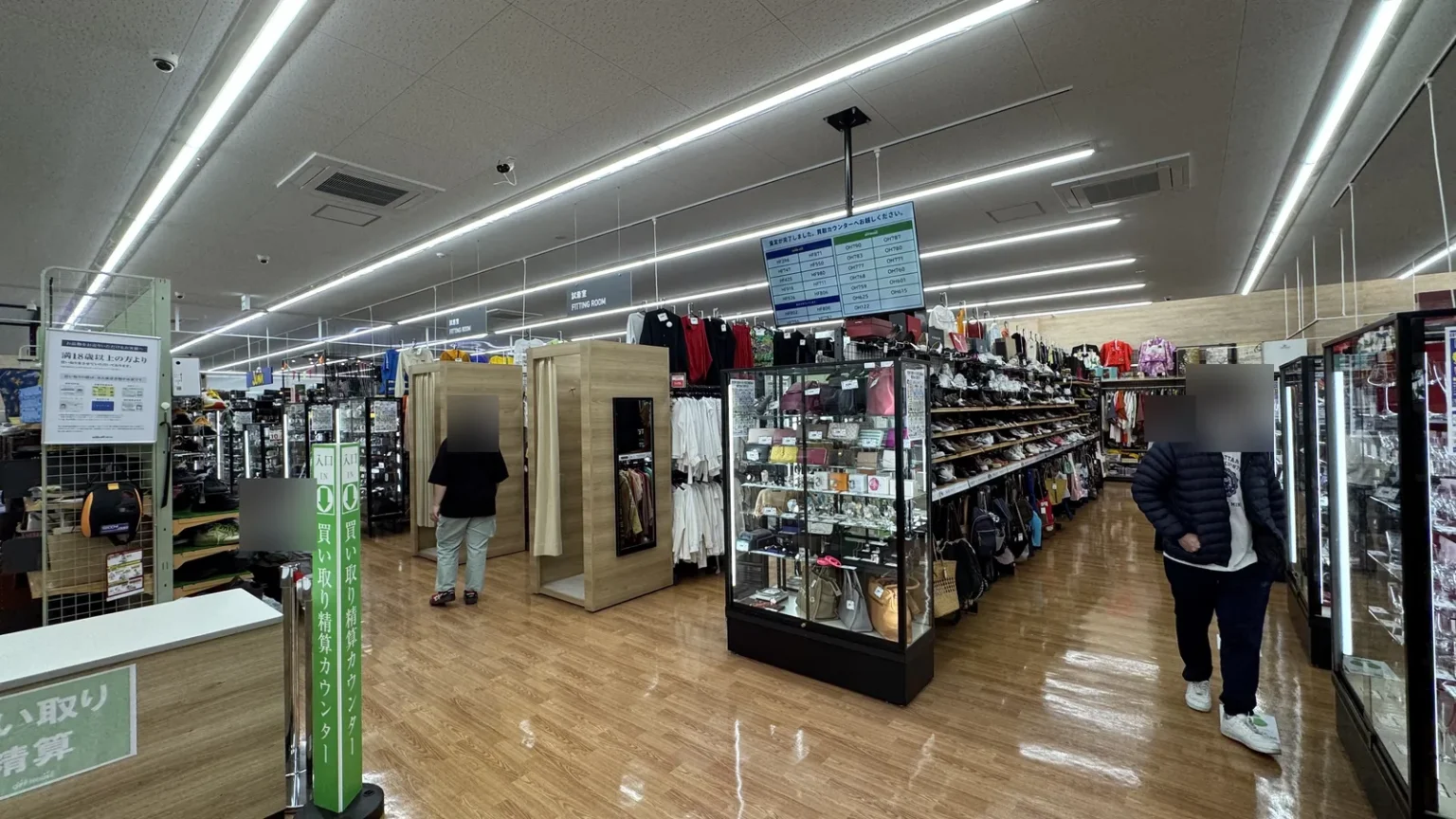 The Off House sales floor with glass cases, shoe shelves and clothing racks, and shoppers with blurred faces