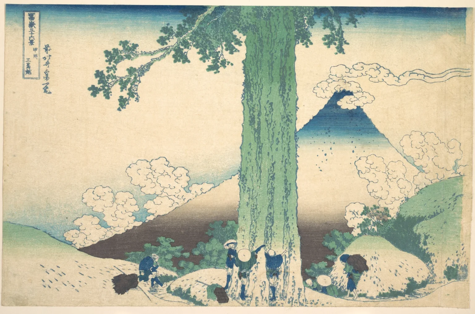 Woodblock print: an enormous tree trunk rises through the centre of the picture. Three travellers stand at its base with their arms stretched around it, hands linked, while others rest nearby. Behind the tree rises Mount Fuji, deep blue on its upper slopes, among billowing white clouds.