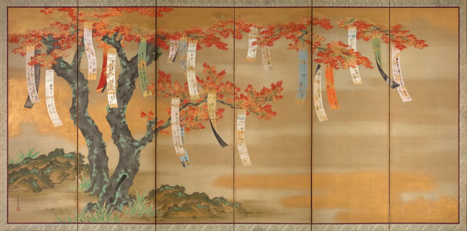 A six-panel folding screen on a gold ground: an old maple with a thick, dark trunk spreads red and orange leaves across all six panels, with long paper strips inscribed with poems hanging from its branches.