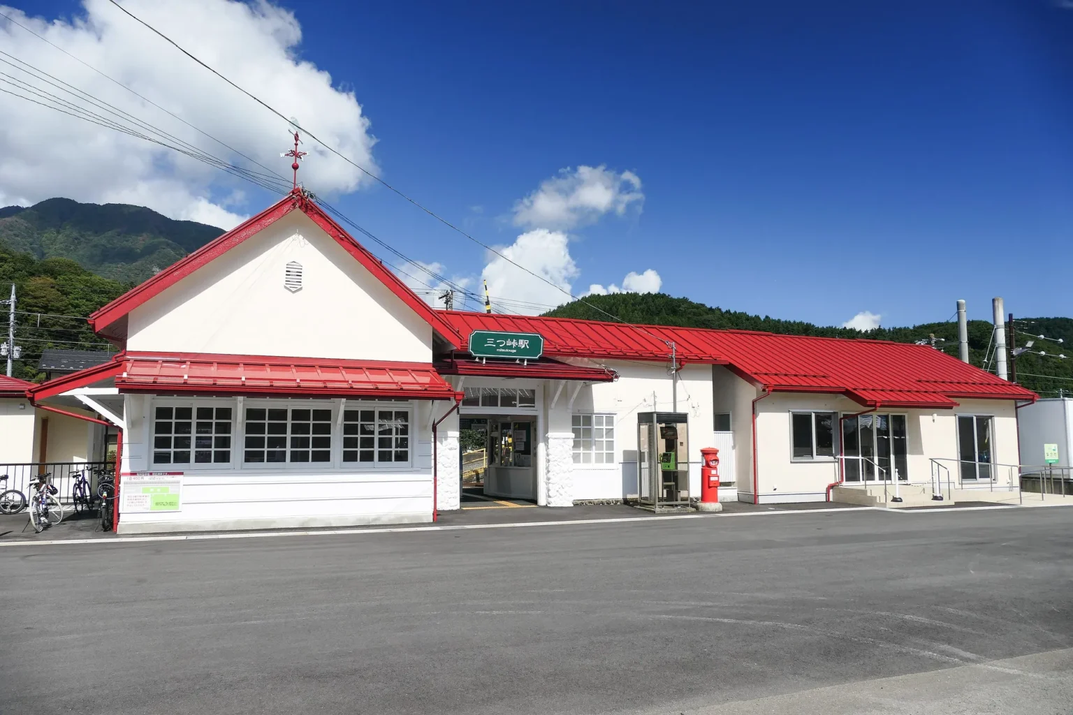 Mitsutoge Station, a small white building with red roofs.