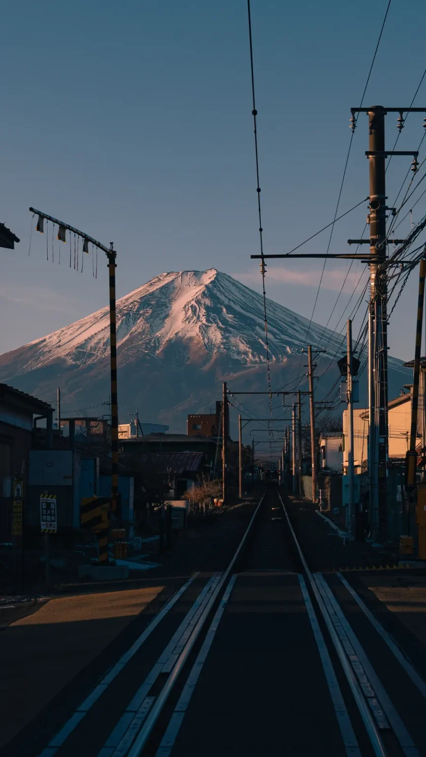 A railway track running towards Mt Fuji at dawn.
