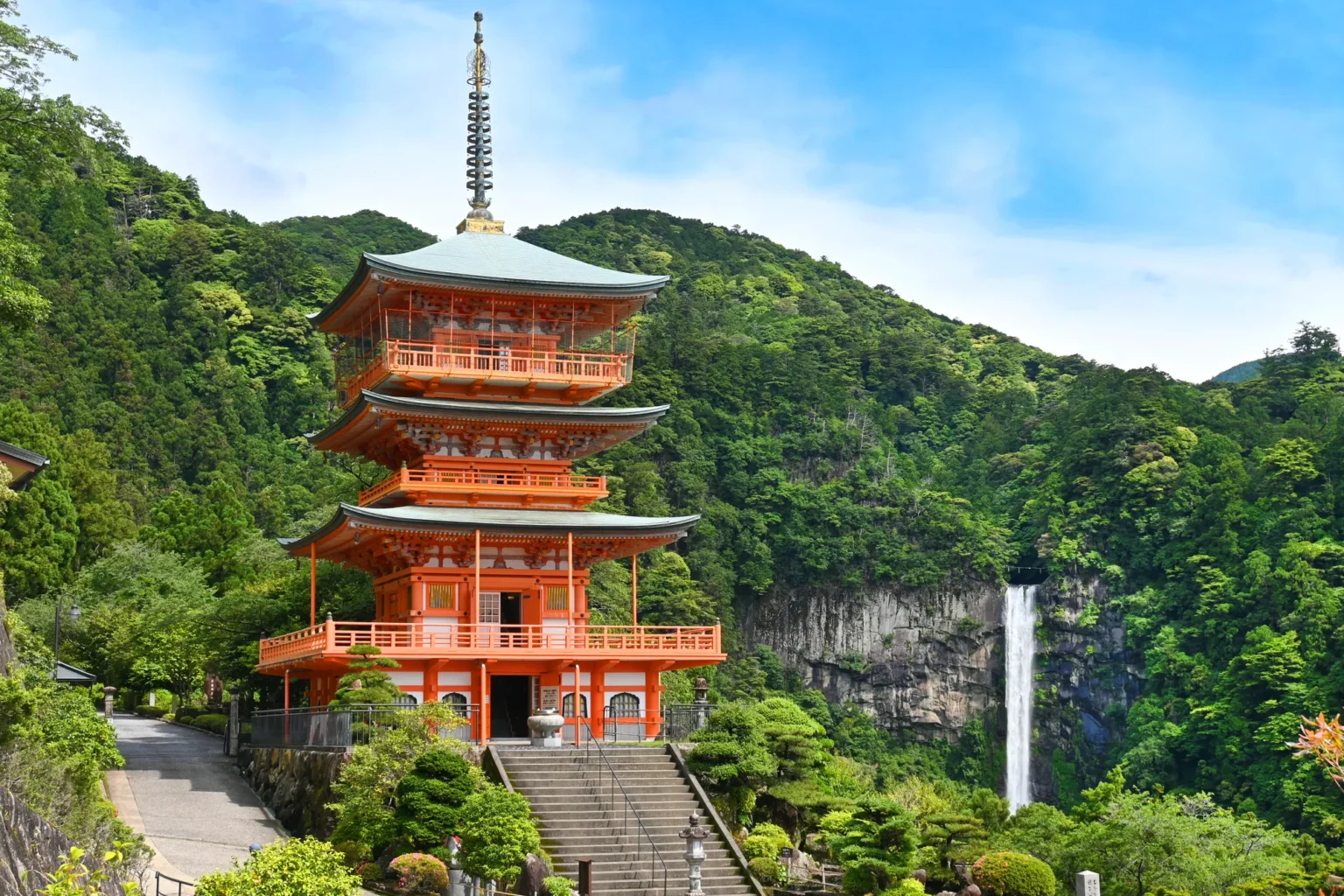 Seiganto-ji's red three-storied pagoda with Nachi Falls behind, Wakayama
