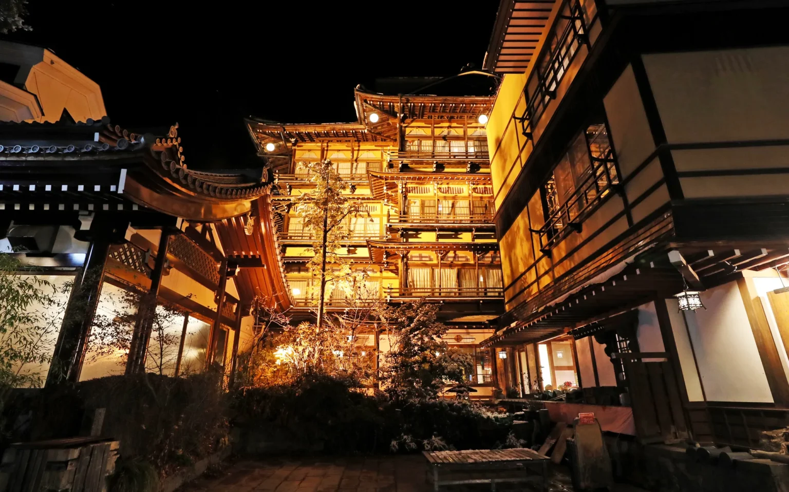 Multi-storey wooden inns lit up at night in Shibu Onsen, Nagano