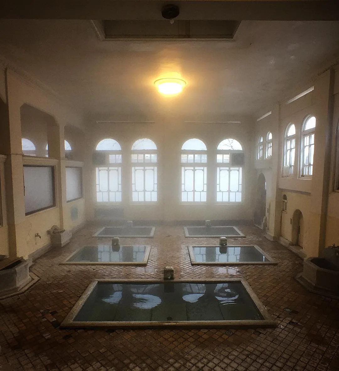 Interior of Genroku-no-yu bath at Sekizenkan, Shima Onsen, with arched windows