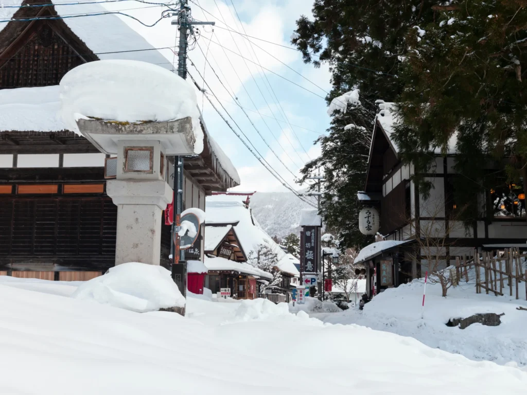 Deep snow on the shukubo inns and stone lantern near Chusha, Togakushi, in midwinter