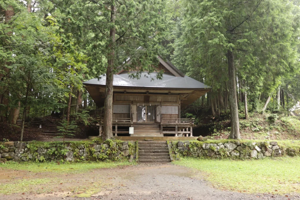 Small wooden Hinomikosha hall among tall trees, Togakushi Shrine, Nagano