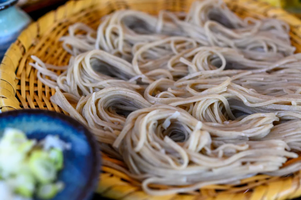 Togakushi soba served in a round bamboo basket with condiments